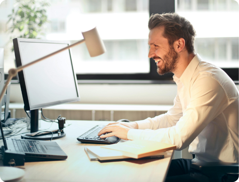 Man at computer smiling